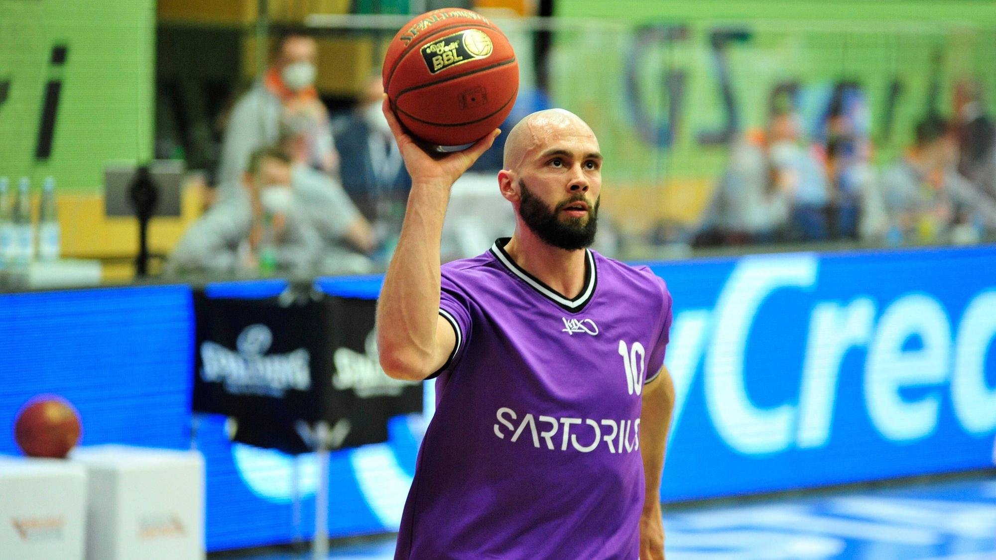 Dennis Kramer hält beim Aufwärmprogramm einen Basketball in der Hand.
