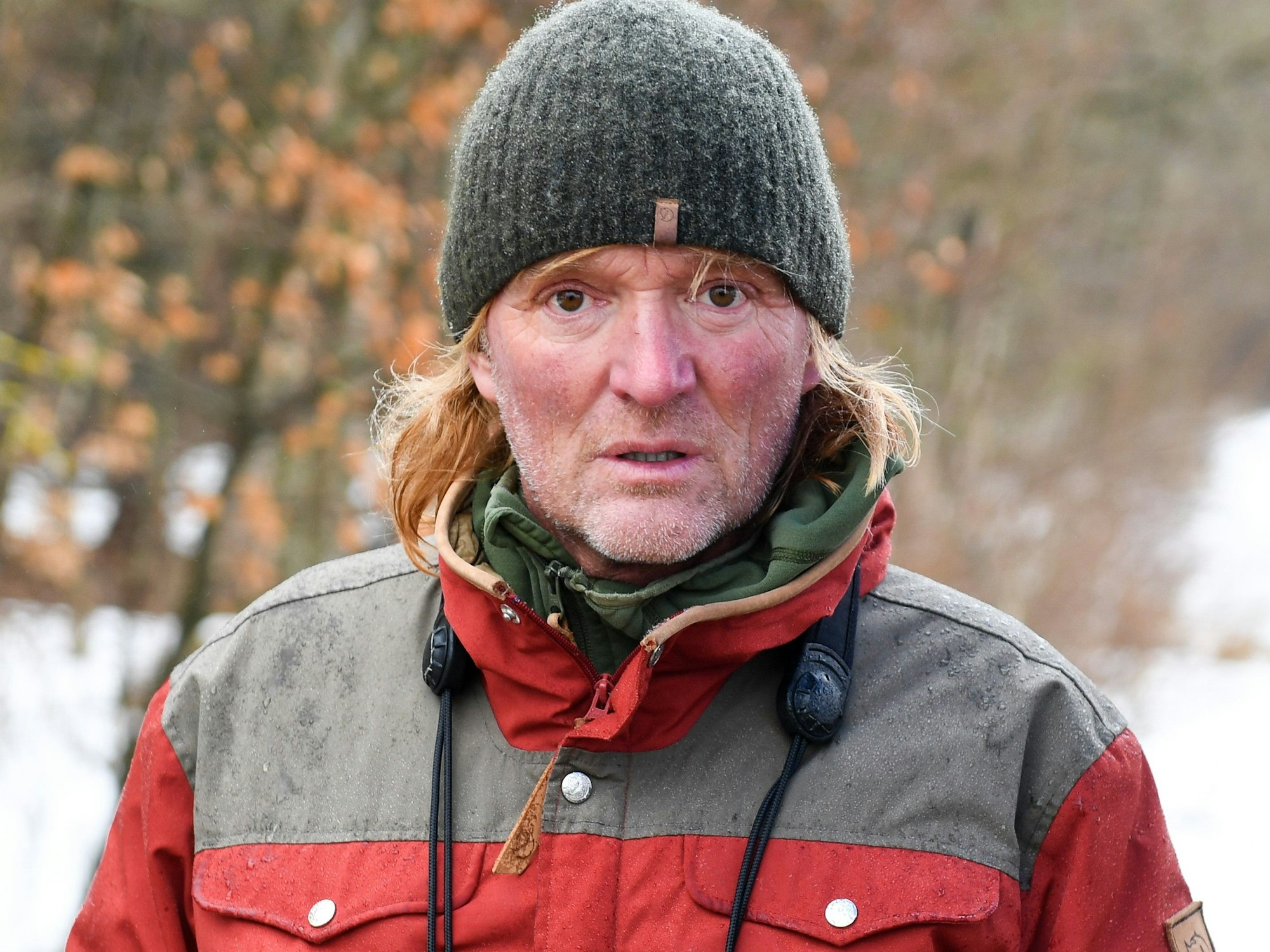 Der Dokumentarfilmer Andreas Kieling posiert im Schnee für ein Foto. Er trägt eine Winterjacke und eine Mütze.