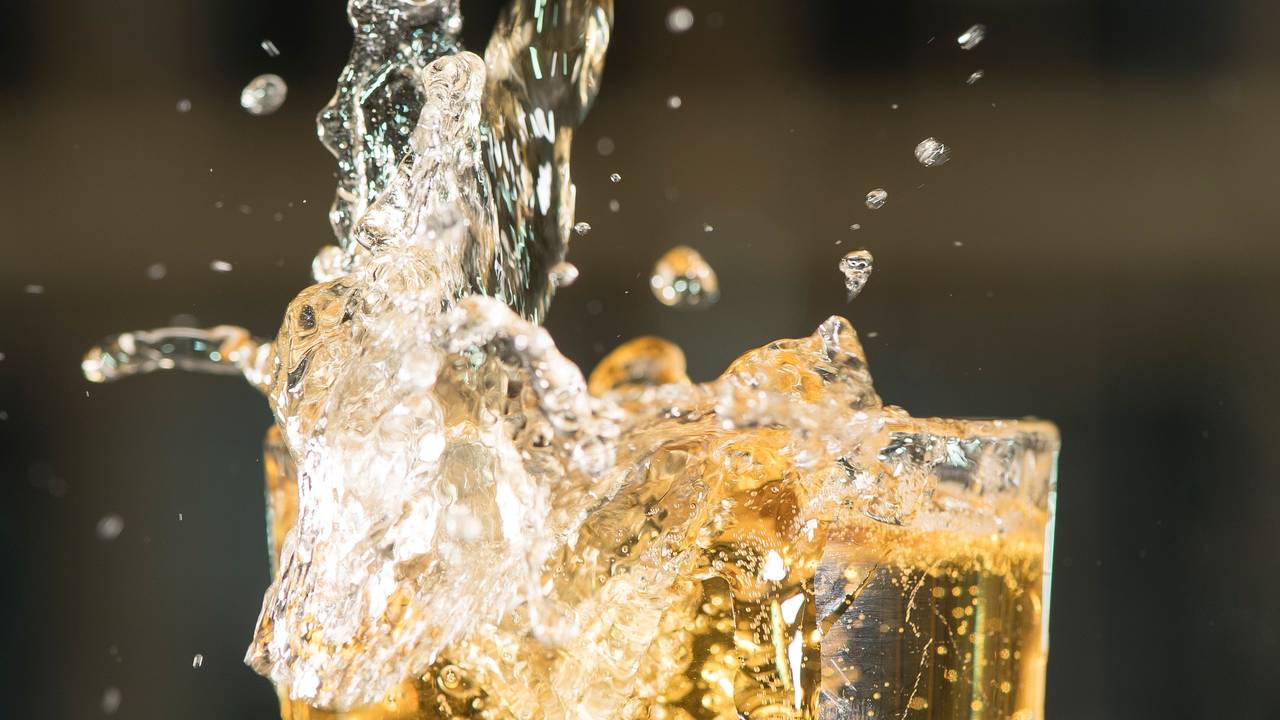 Apfelschorle schwappt aus einem Glas, hier im März 2019 in Berlin.