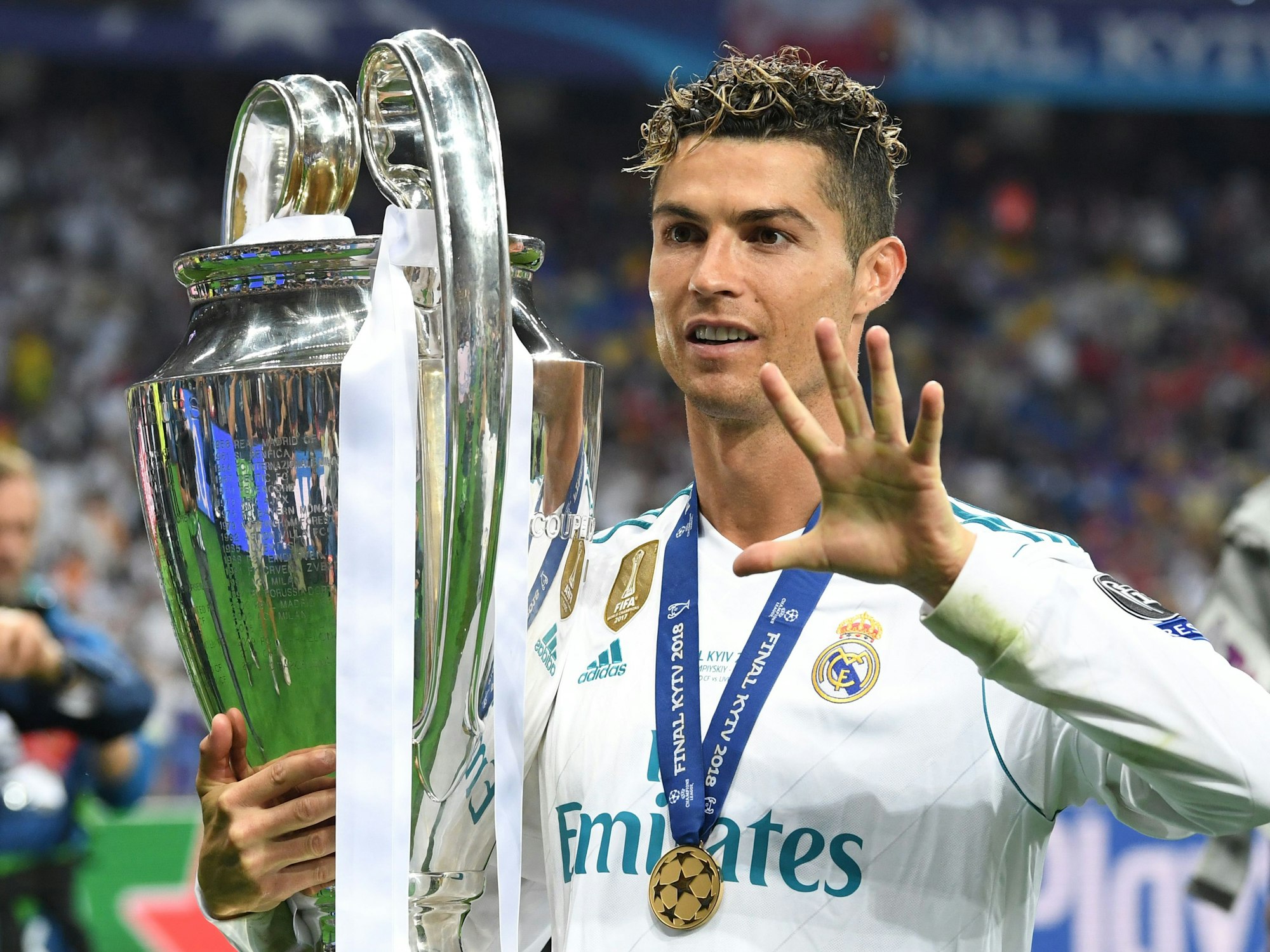 Madrids Cristiano Ronaldo jubelt mit dem Champions League Pokal und zeigt eine Fünf an.