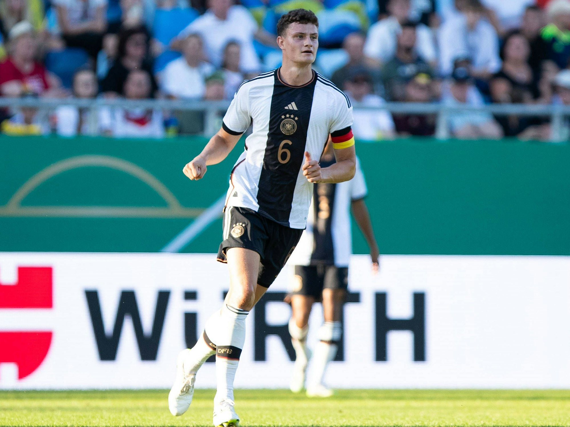 Eric Martel läuft mit Kapitänsbinde über den Platz.