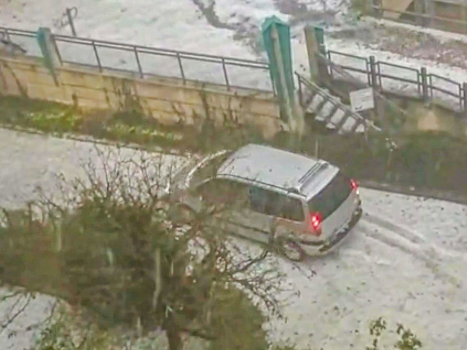 Ein Auto steht inmitten der Hagelmassen in Worms, welche die Stadt in eine Winterlandschaft verwandelte.