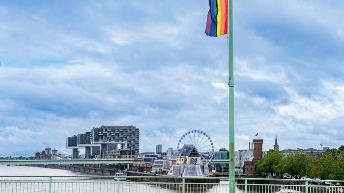 Eine Regenbogenfahne hängt auf der Deutzer Brücke in der Kölner Innenstadt.