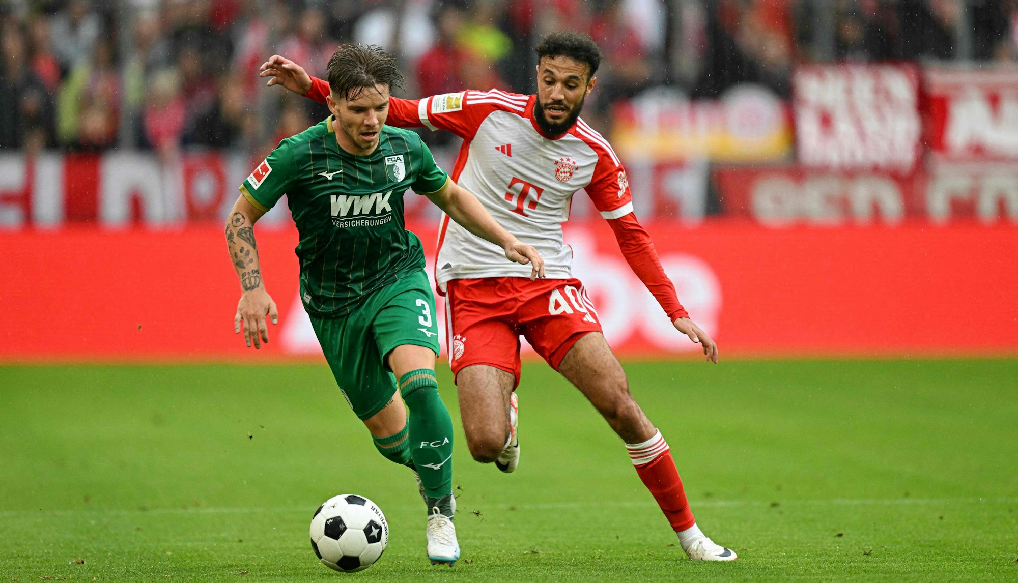 Bayerns Noussair Mazraoui (r.) verfolgt Augsburgs Mads Pedersen.