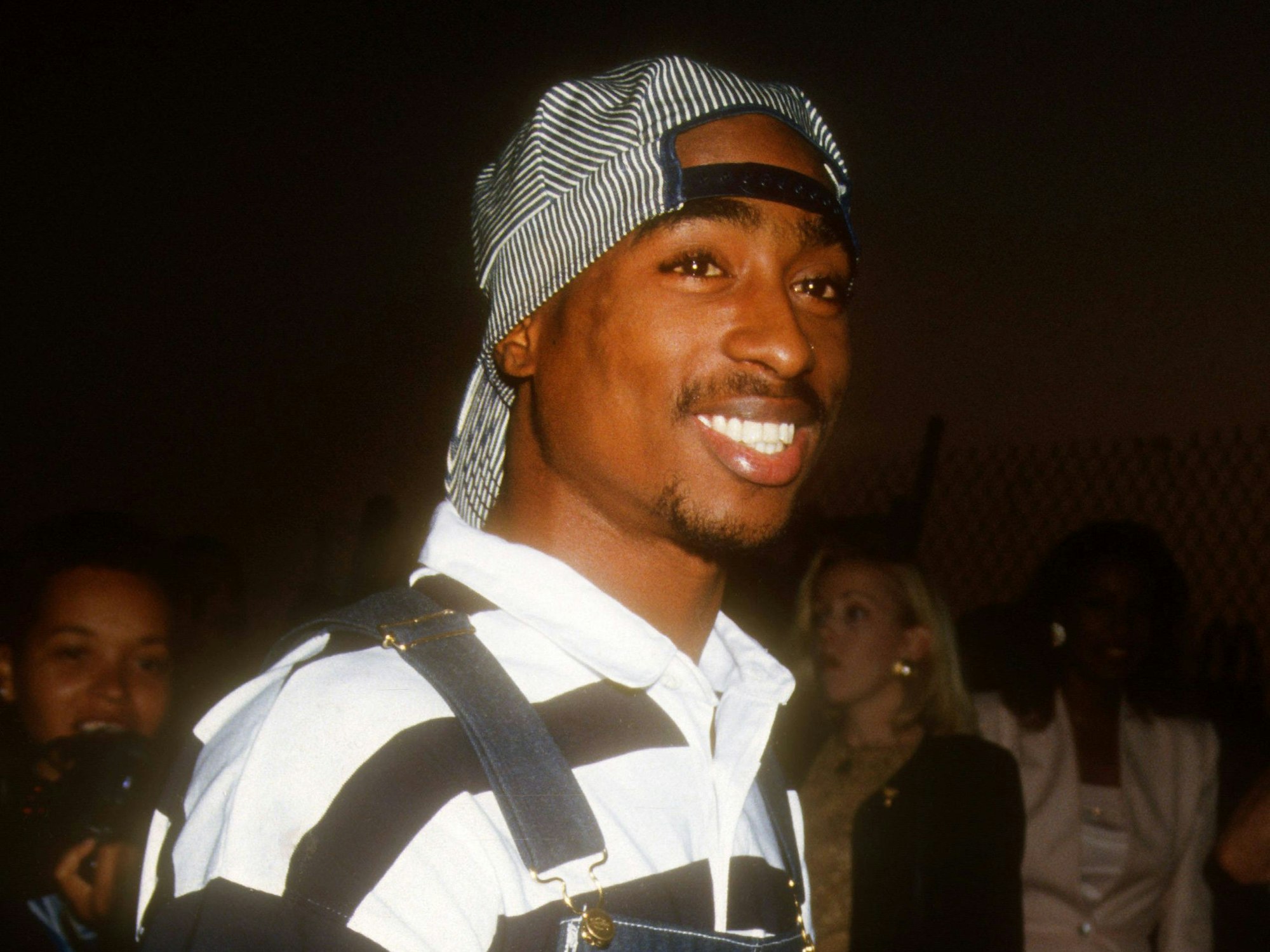 Rapper Tupac Shakur lächelt.