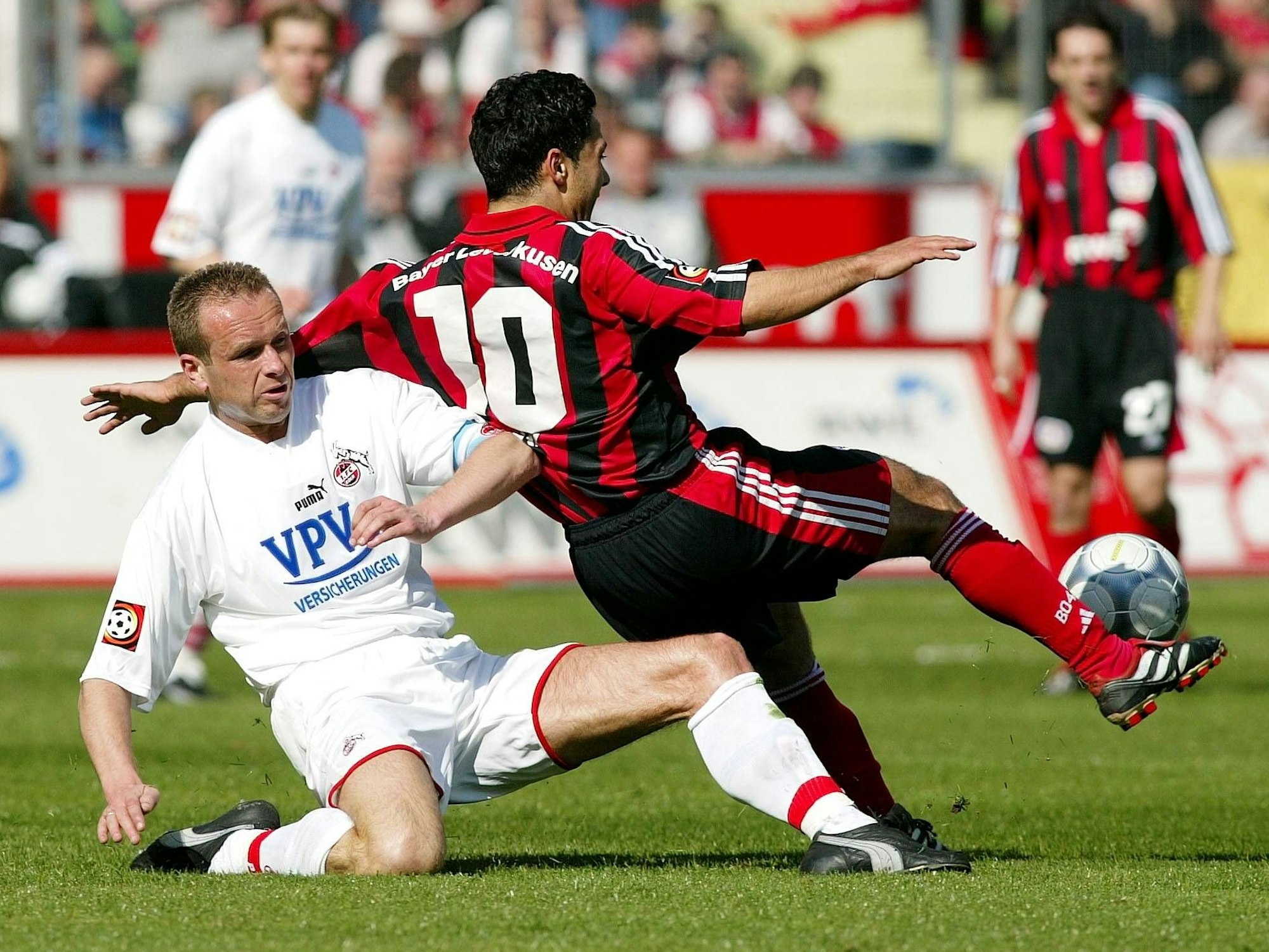 Dirk Lottner (li., Köln) säbelt Yildiray Bastürk (Leverkusen) um.