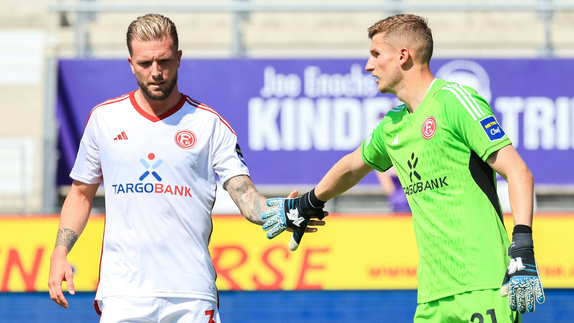 Keeper Dennis Gorka klatscht mit Fortuna Düsseldorfs Kapitän Andre Hoffmann ab.
