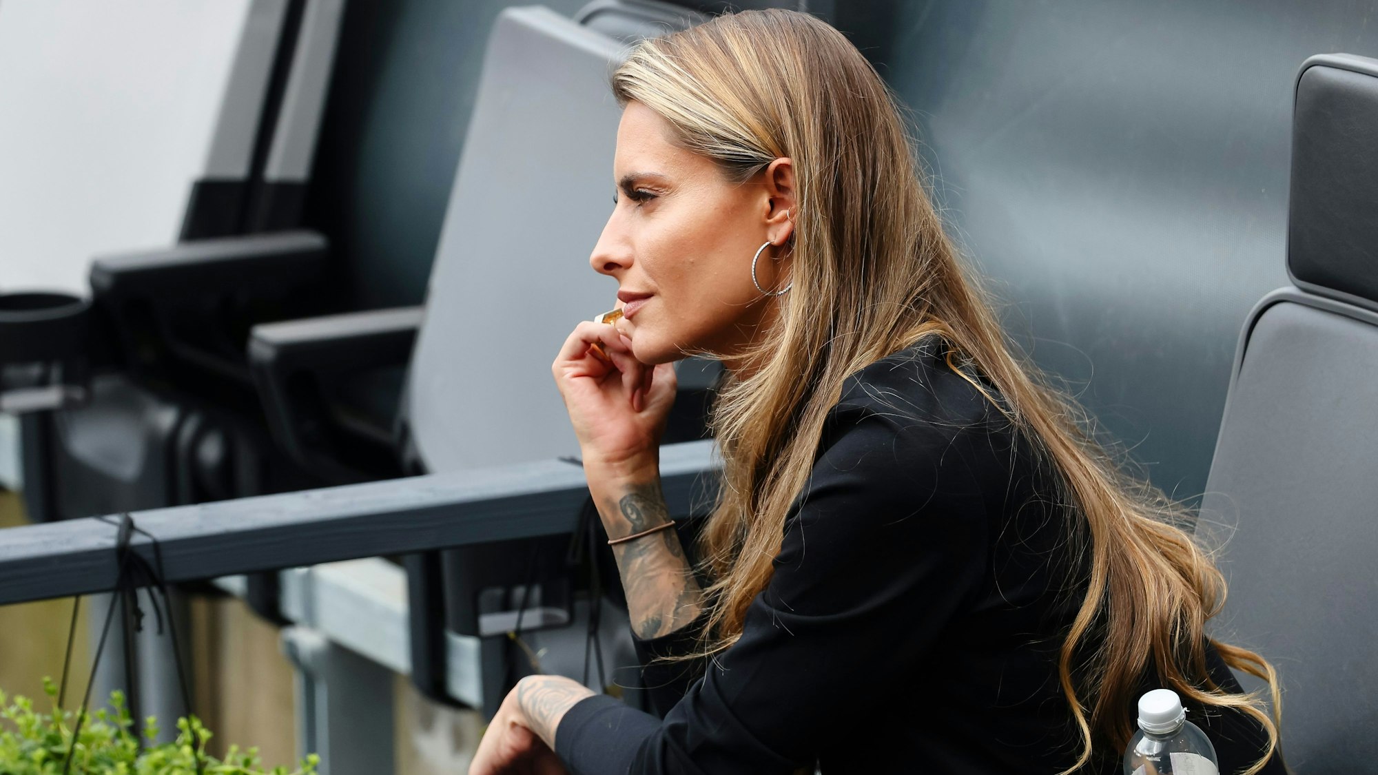 Sophia Thomalla sitzt auf der Tribüne.
