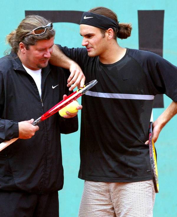 Roger Federer spricht bei einem Training mit seinem Coach Peter Lundgren. Sein rechter Arm liegt auf der Schulter des Schweden.