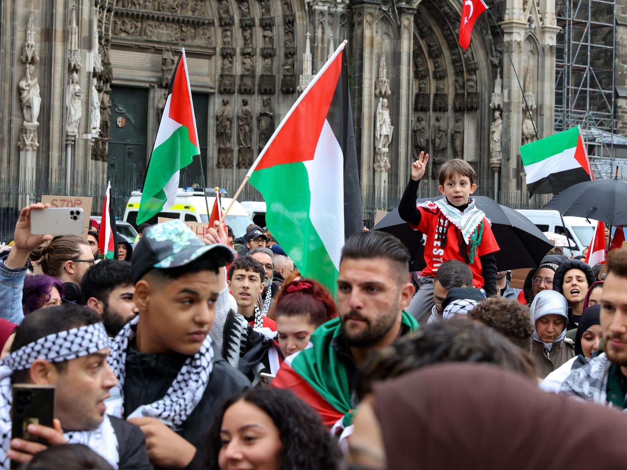 Menschen demonstrieren vor dem Kölner Dom.