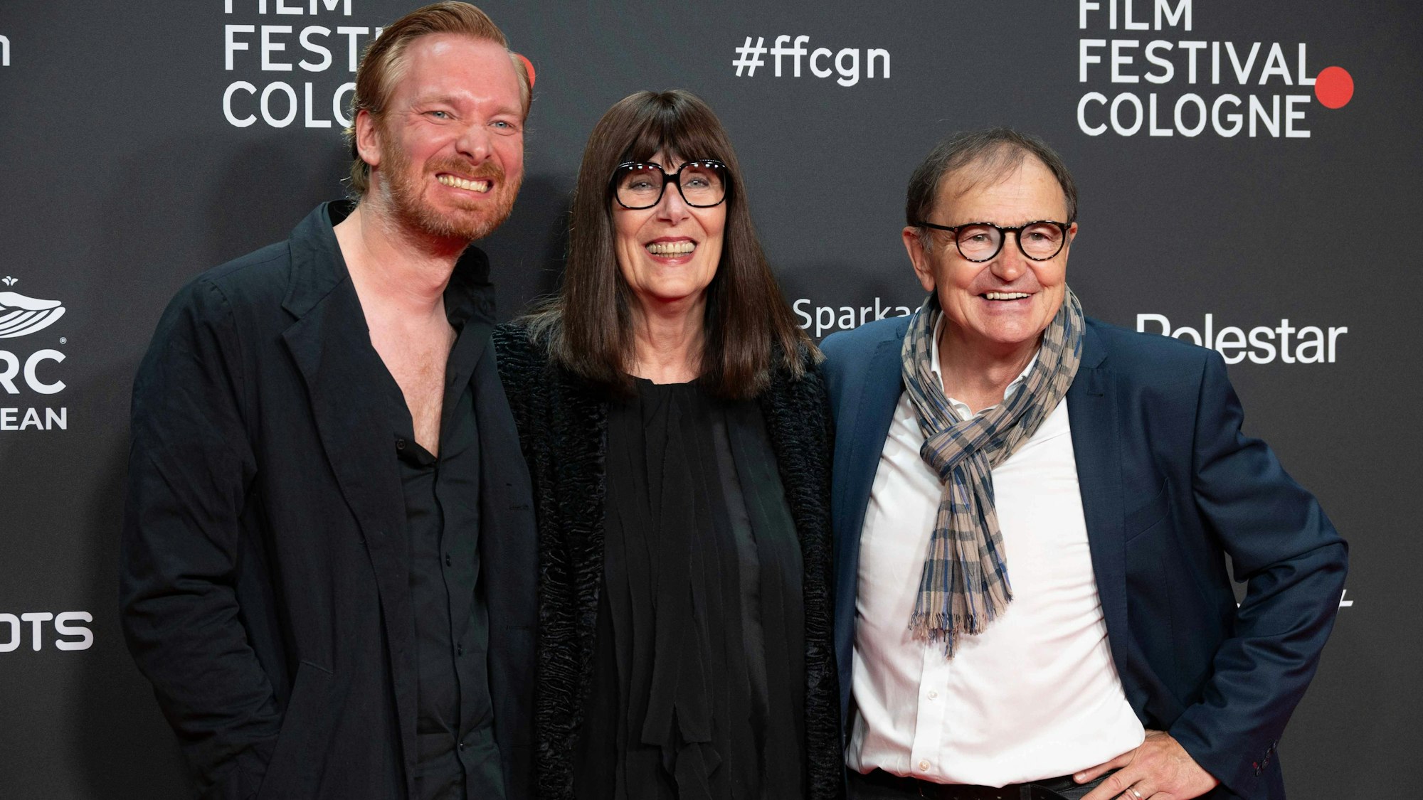 Jesper Petzke zusammen mit Ewald Lienen und dessen Ehefrau Rosa auf dem roten Teppich.