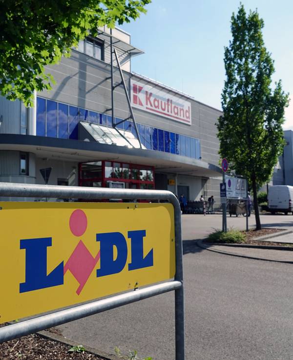 Ein Schild weist auf eine Filiale des Lebensmitteldiscounters Lidl hin. Im Hintergrund befindet sich eine Filiale des Großflächen-Discounters Kaufland.