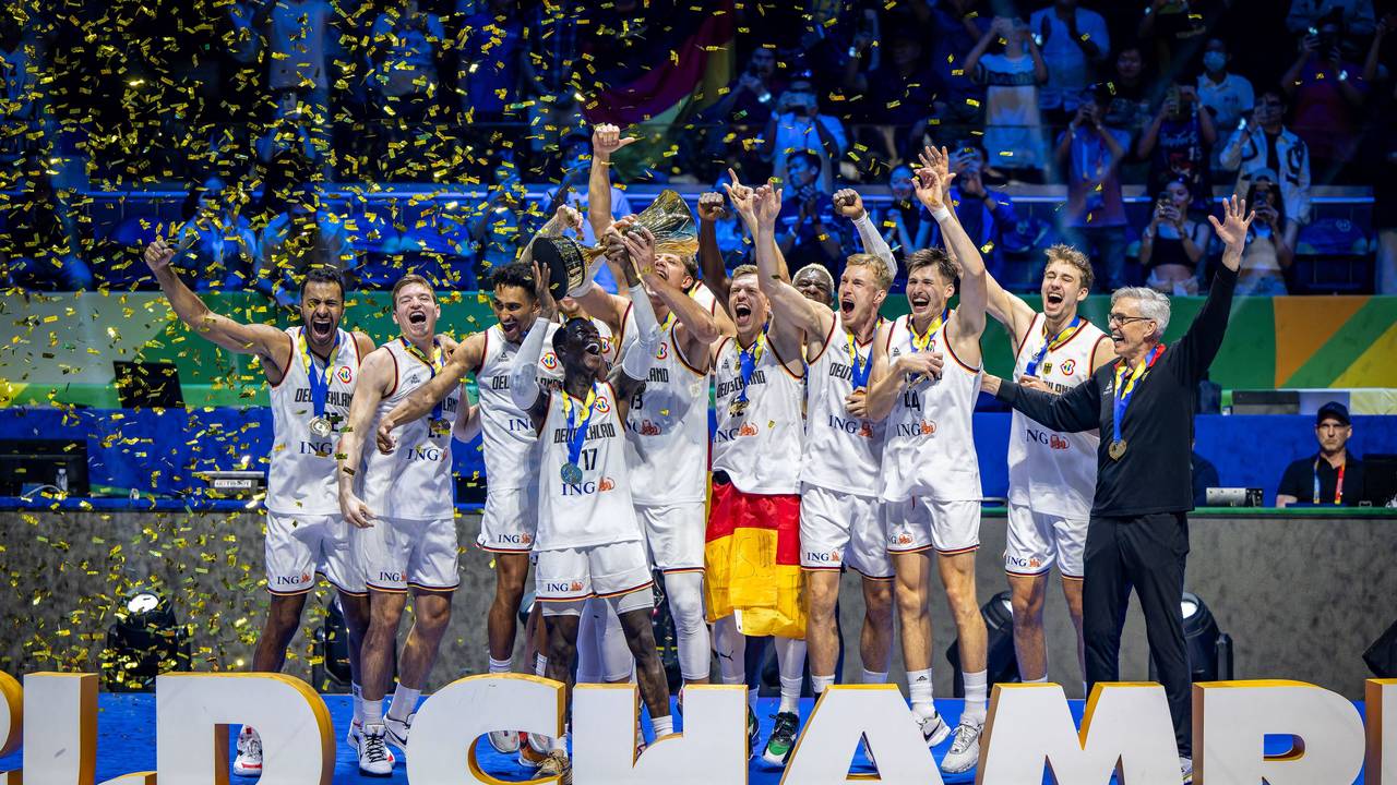 Die deutschen Basketballer stemmen den WM-Pokal in die Luft.