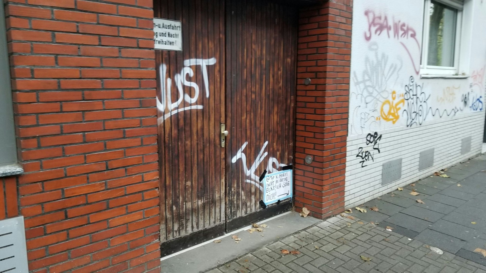 Ein Garagentor mit einem Schild in der Ecke.