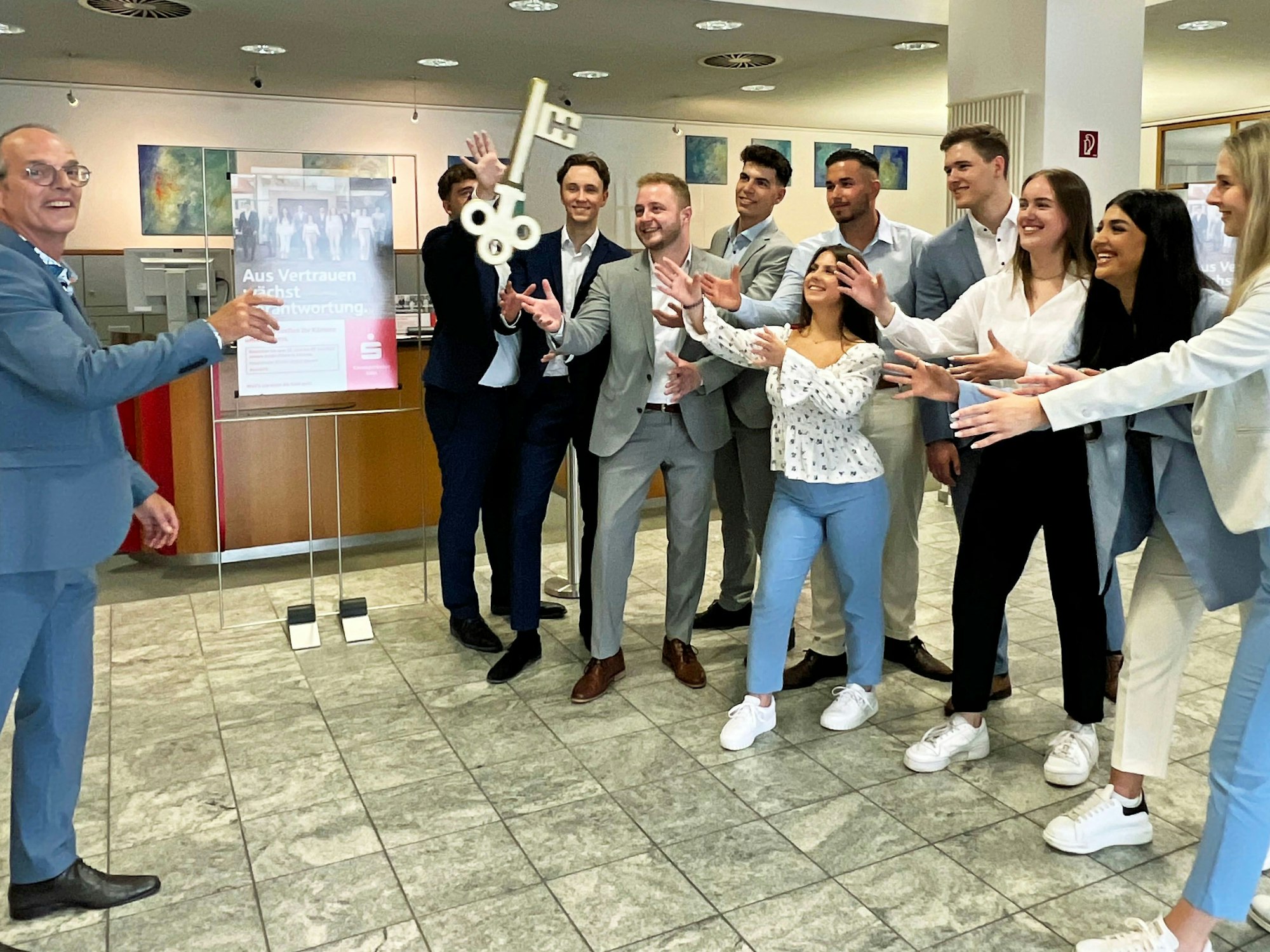 Frank Kasolowsky, Leiter der Kreissparkasse Köln in Rösrath, übergab zum Start der Azubi-Filiale symbolisch den Schlüssel an zehn angehende Bankkaufleute. Das Aufnahmedatum des Fotos ist unbekannt.