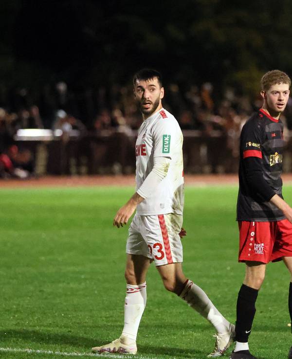 Sargis Adamyan neben einem Gegenspieler der SpVg Porz.