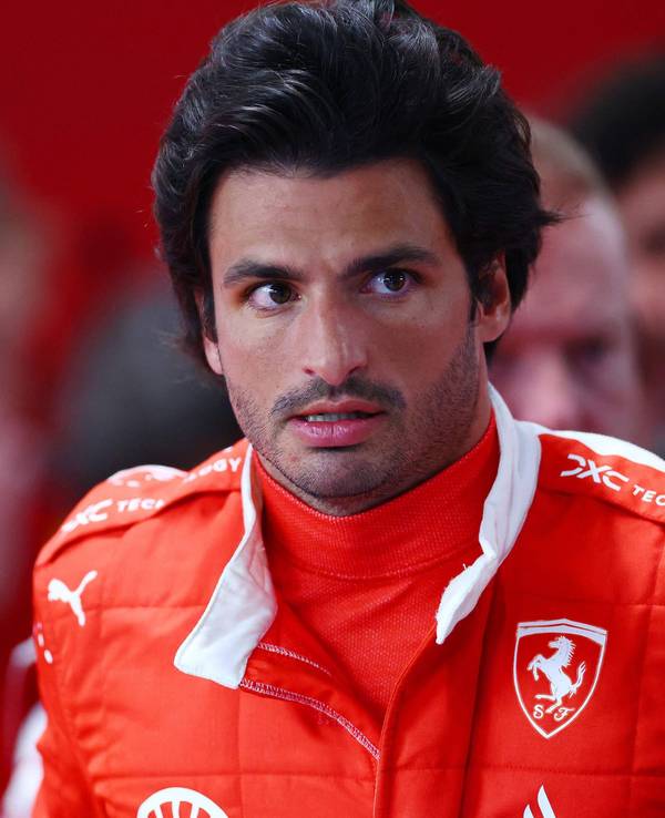 Ferrari-Pilot Carlos Sainz steht in der Boxengasse von Ferrari.