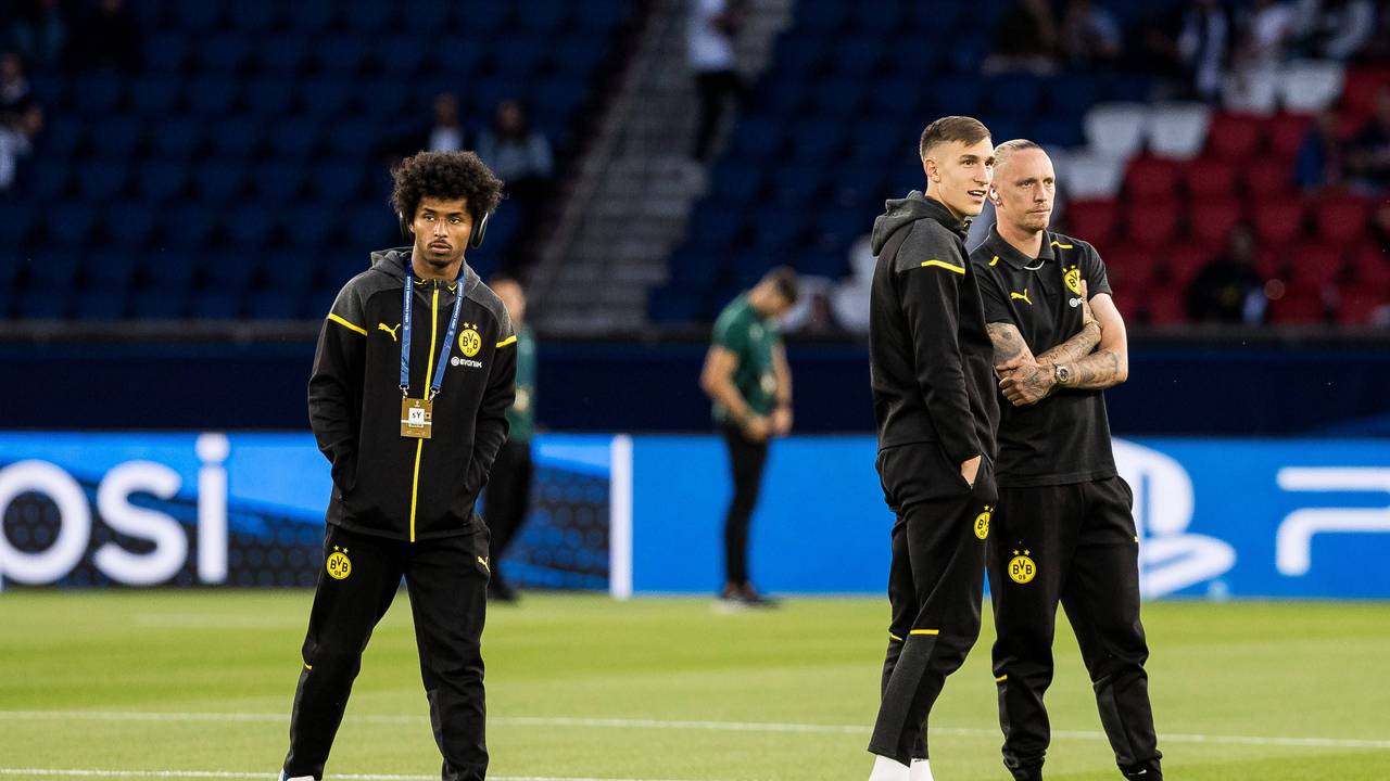 Karim Adeyemi, Nico Schlotterbeck und Marius Wolf vor einem Champions-League-Spiel auf dem Rasen.