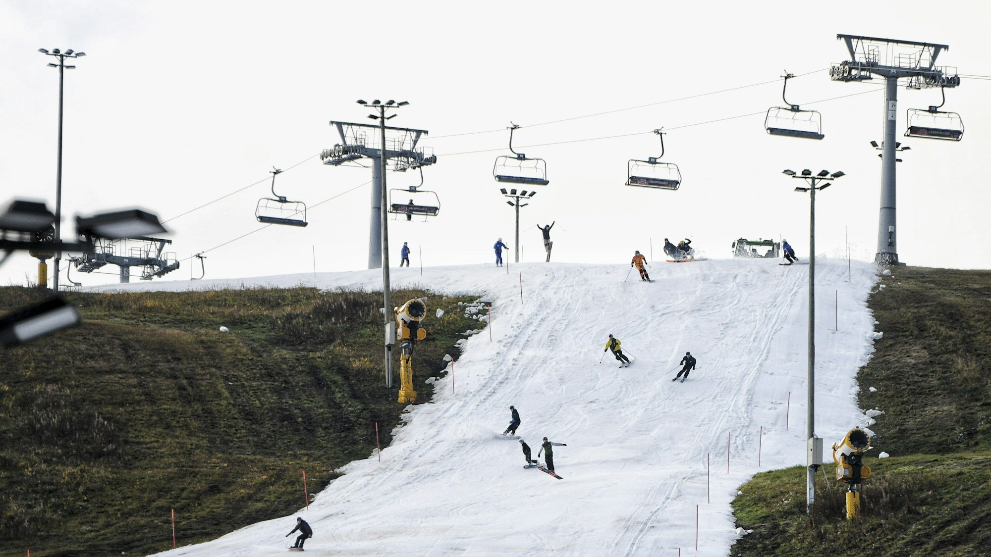 Menschen mit Skiern und Snowboards fahren auf dem Levi Ski Resort zur Eröffnung der Skisaison.