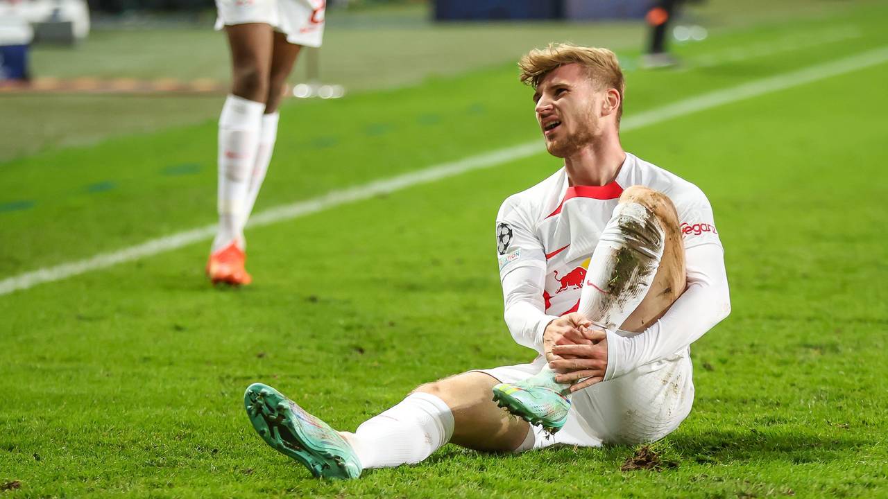 Timo Werner sitzt auf dem Rasen und hält sich das Bein.