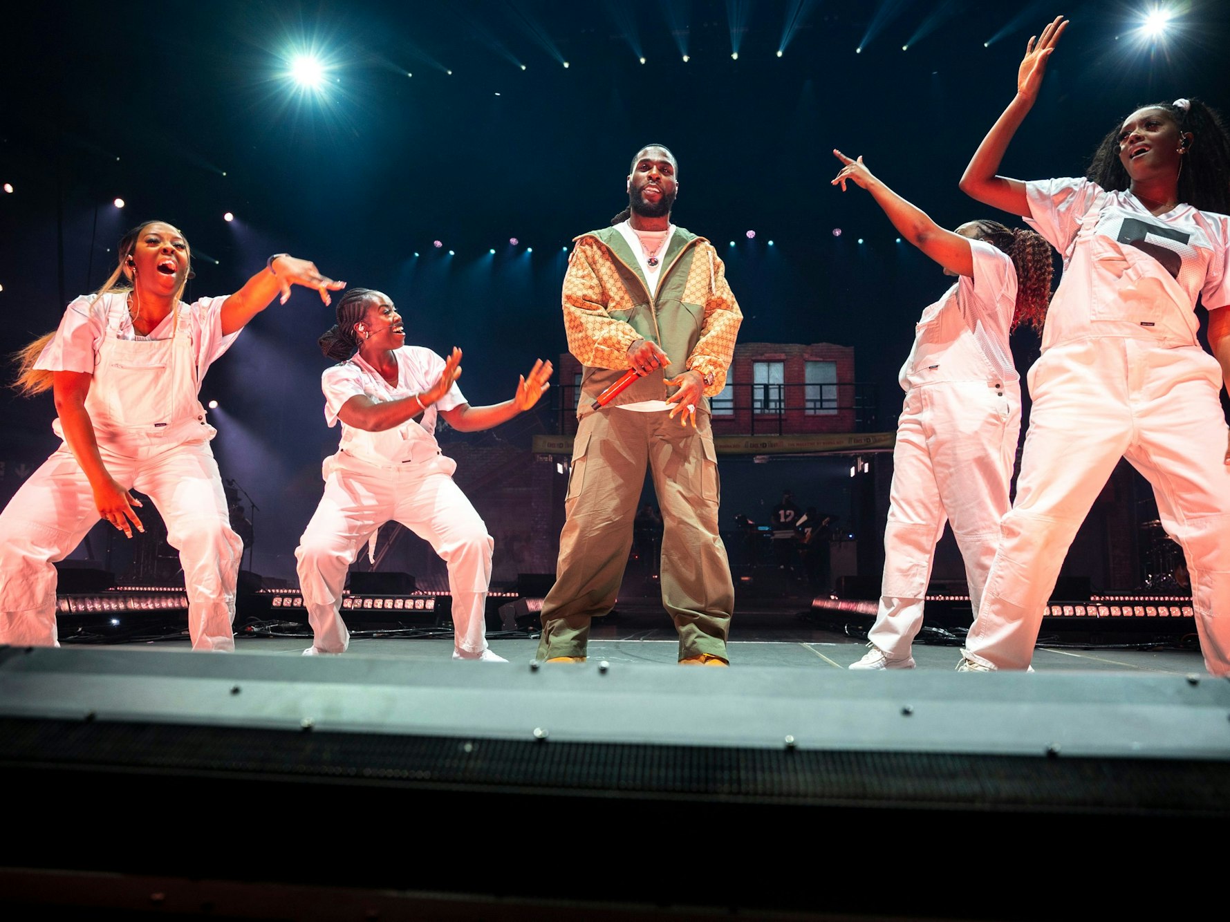 Hier zu sehen: Burna Boy, umringt von vier Tänzerinnen auf der Bühne der Lanxess Arena.