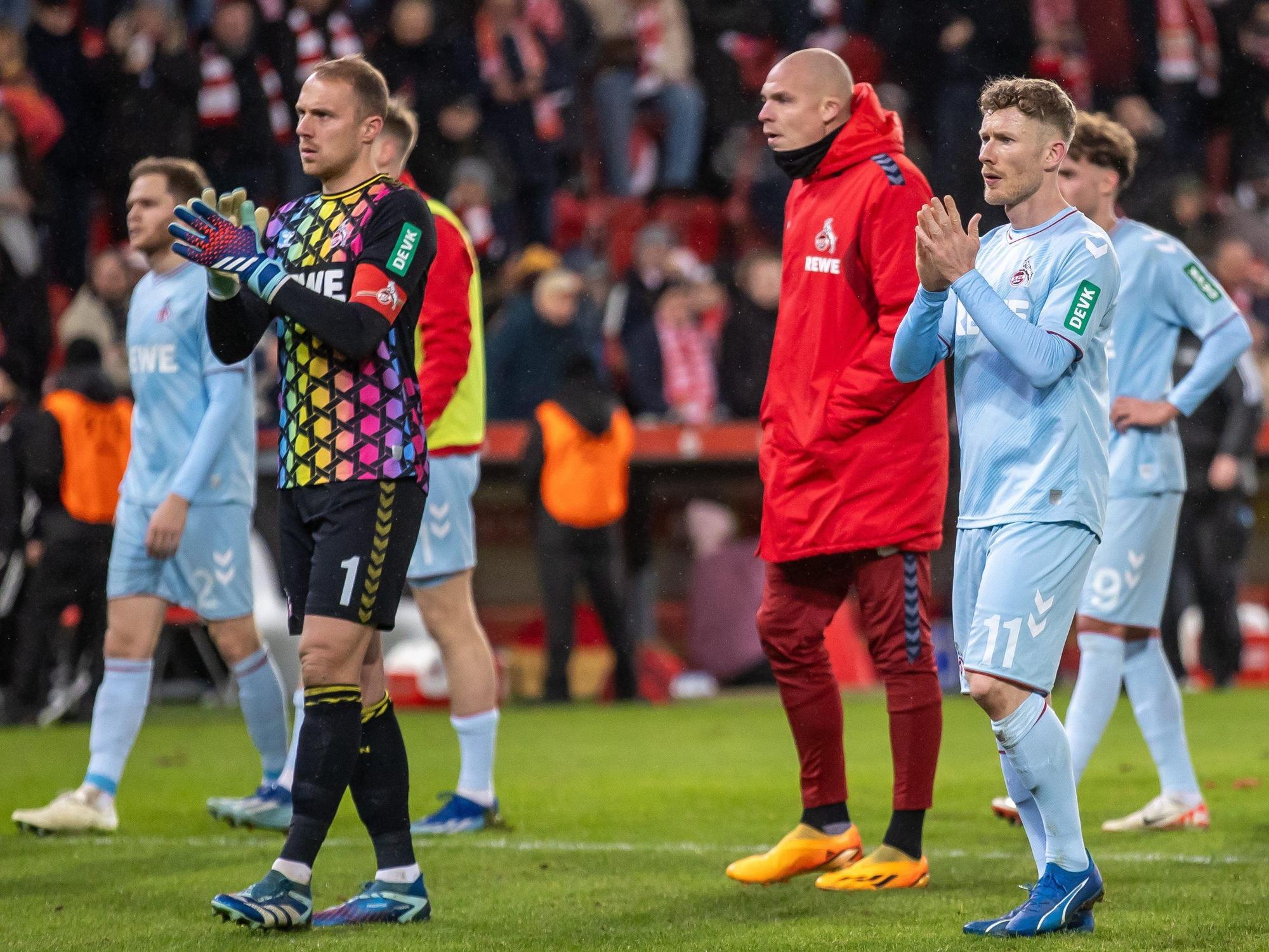 Torwart Marvin Schwäbe (l) von 1. FC Köln und Teamkollegen bedanken sich am 20. Dezember 2023 nach der Niederlage bei den Fans.