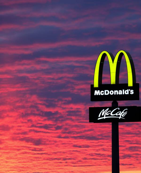 Der Abendhimmel leuchtet hinter einem McDonald's-Logo. McDonald's gibt am 25.04.2023 Zahlen für das 1. Quartal bekannt. +++ dpa-Bildfunk +++