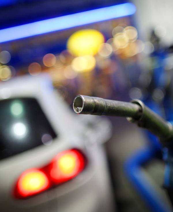 Ein Mann nimmt in Rommerskirchen (Rhein-Kreis Neuss/Nordrhein-Westfalen) an einer Aral-Tankstelle einen Tankrüssel in die Hand, hier im Februar 2014.