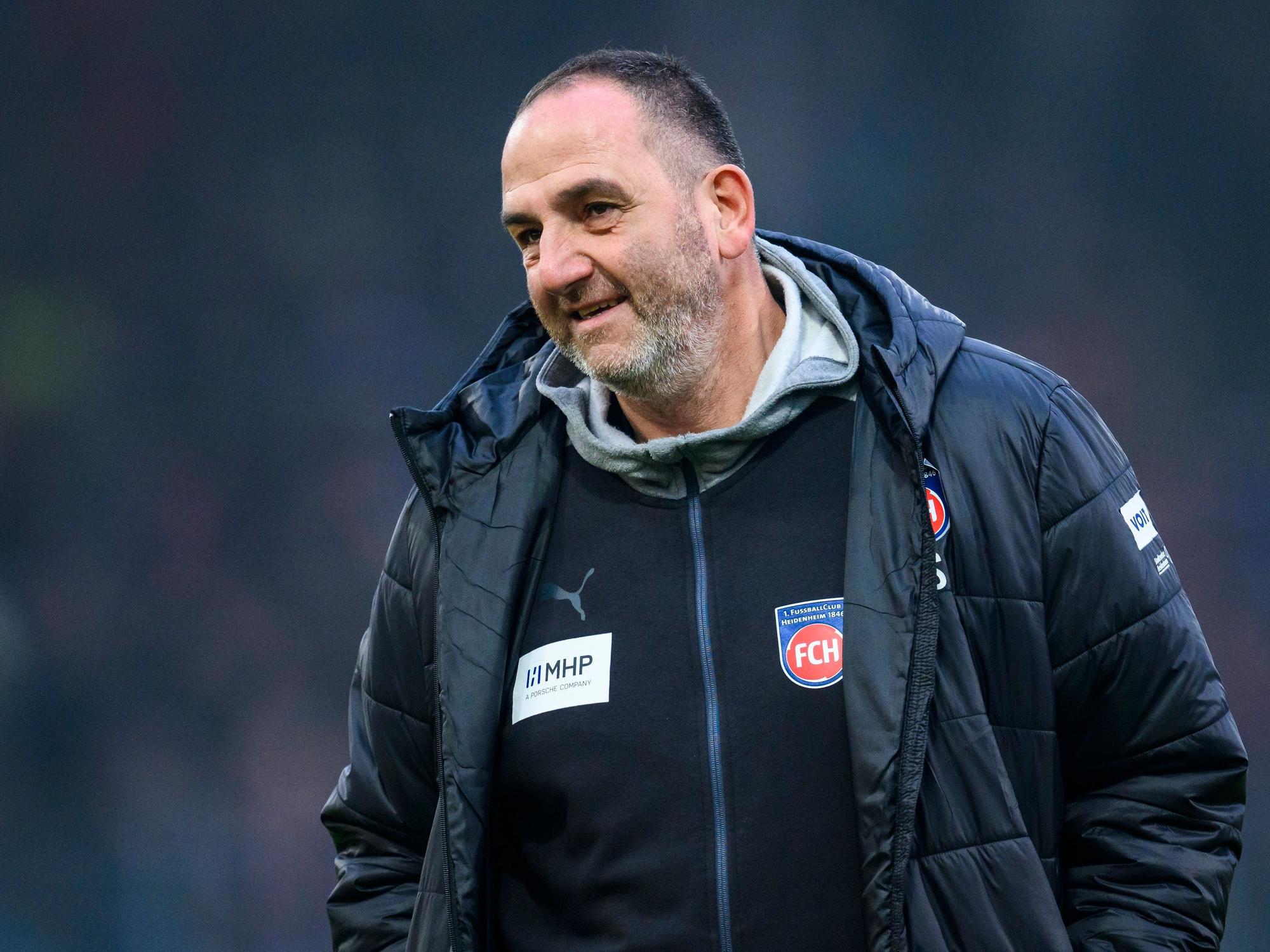 Heidenheims Trainer Frank Schmidt lächelt im Stadion.