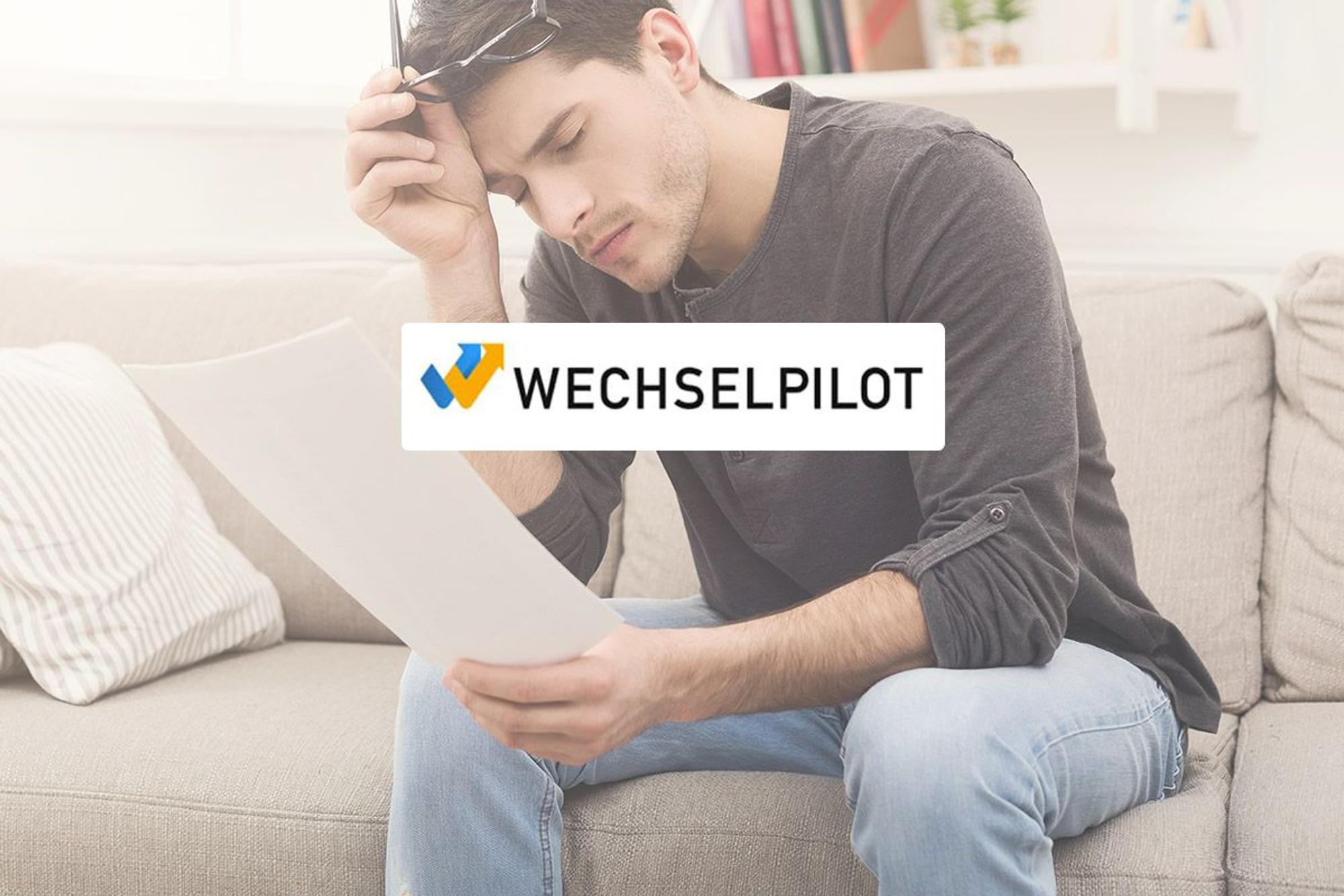 Mann sitzt erschöpft beim Lesen eines Schriftstückes auf der Couch. Logo von Wechselpilot im Bild.
