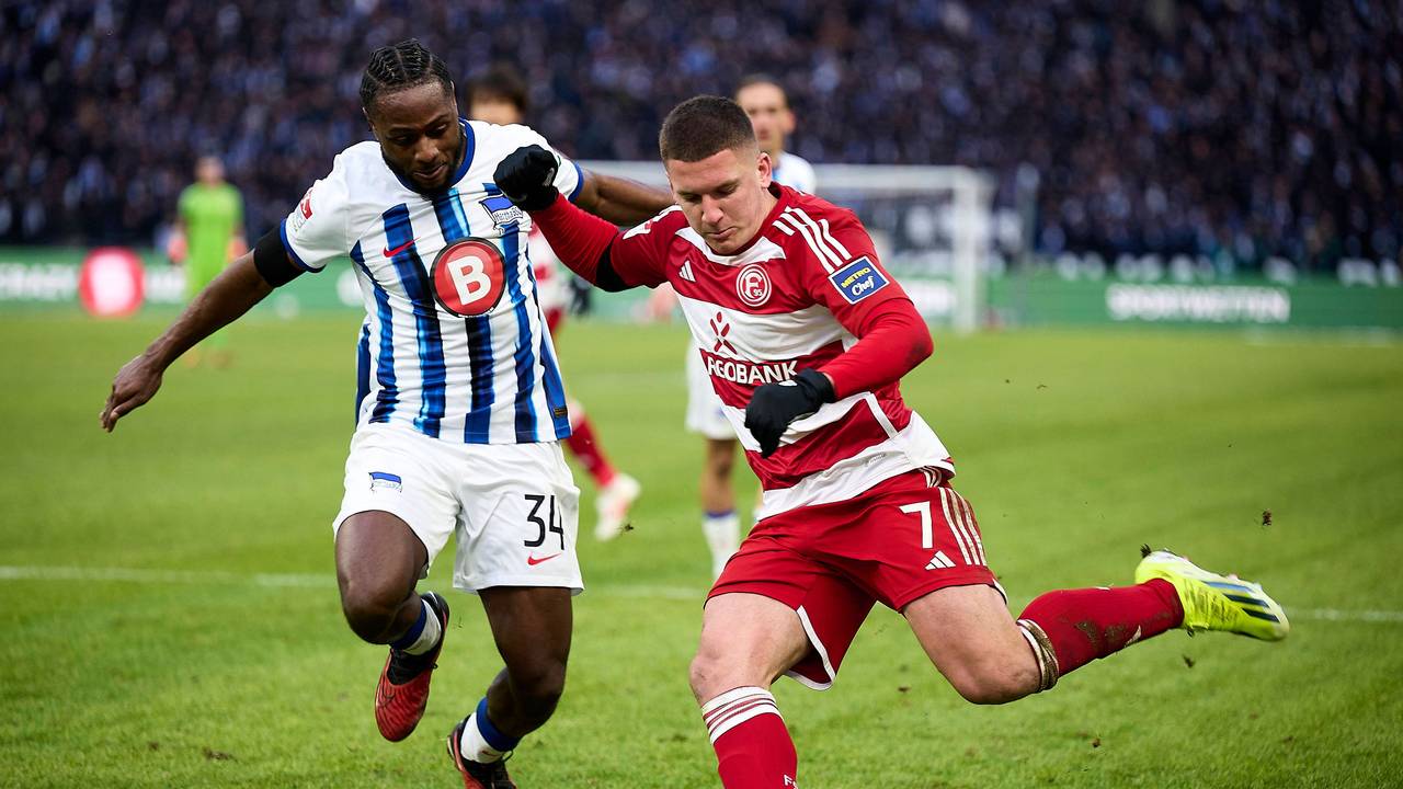 Fortuna Düsseldorfs Christos Tzolis flankt, Herthas Deyovaisio Zeefuik kommt zu spät.