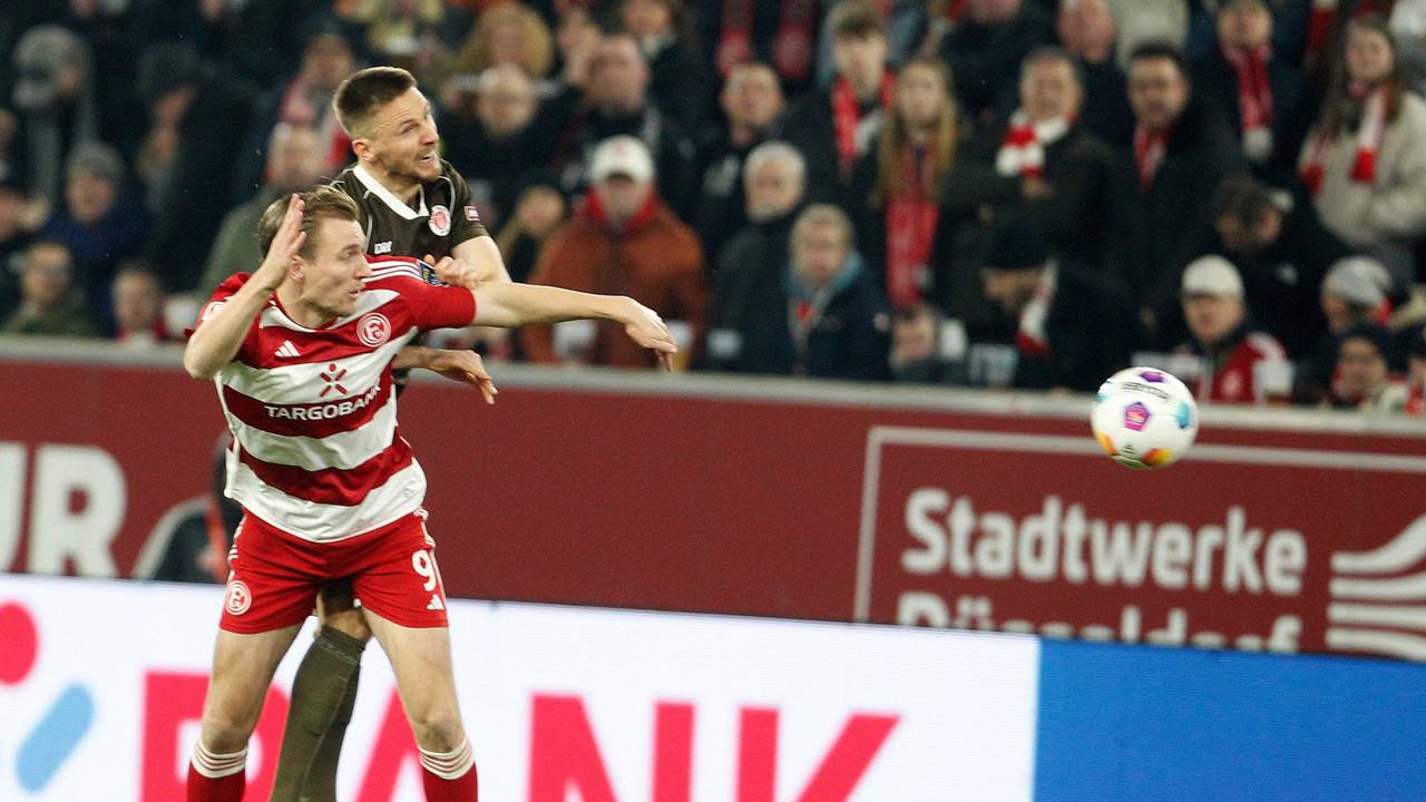 Fortuna Düsseldorfs Vincent Vermeij im Kopfballduell mit St. Paulis Karol Mets.