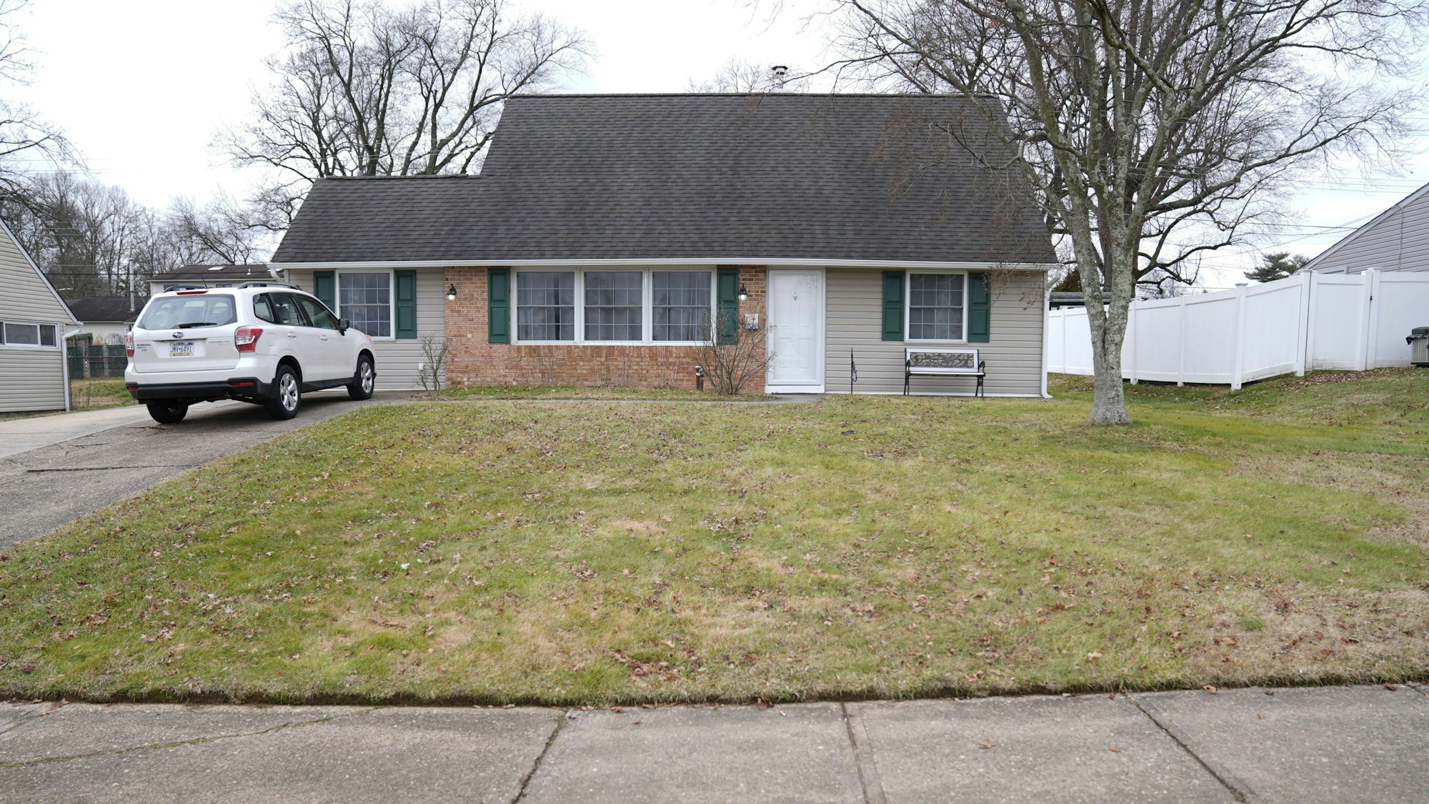 Ein Fahrzeug ist in der Einfahrt eines Hauses geparkt, das Schauplatz eines Mordes war.