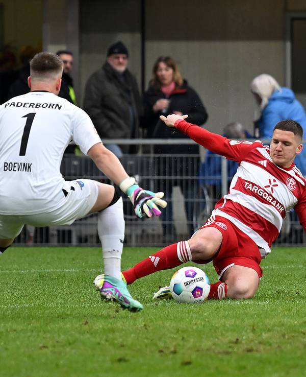 Fortuna Düsseldorfs Christos Tzolis grätscht nach dem Ball, Paderborns Keeper Pelle Boevik versucht zu parieren.