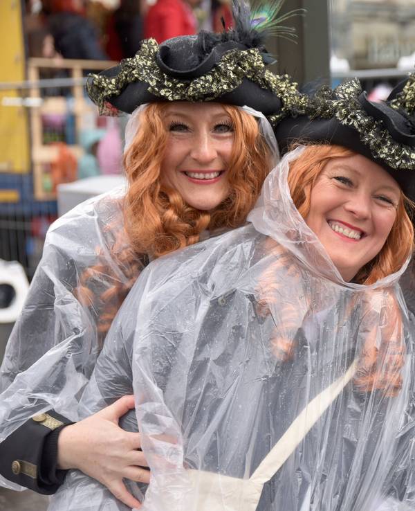 Drei Jecke mit Regenponchos am Neumarkt in Köln
