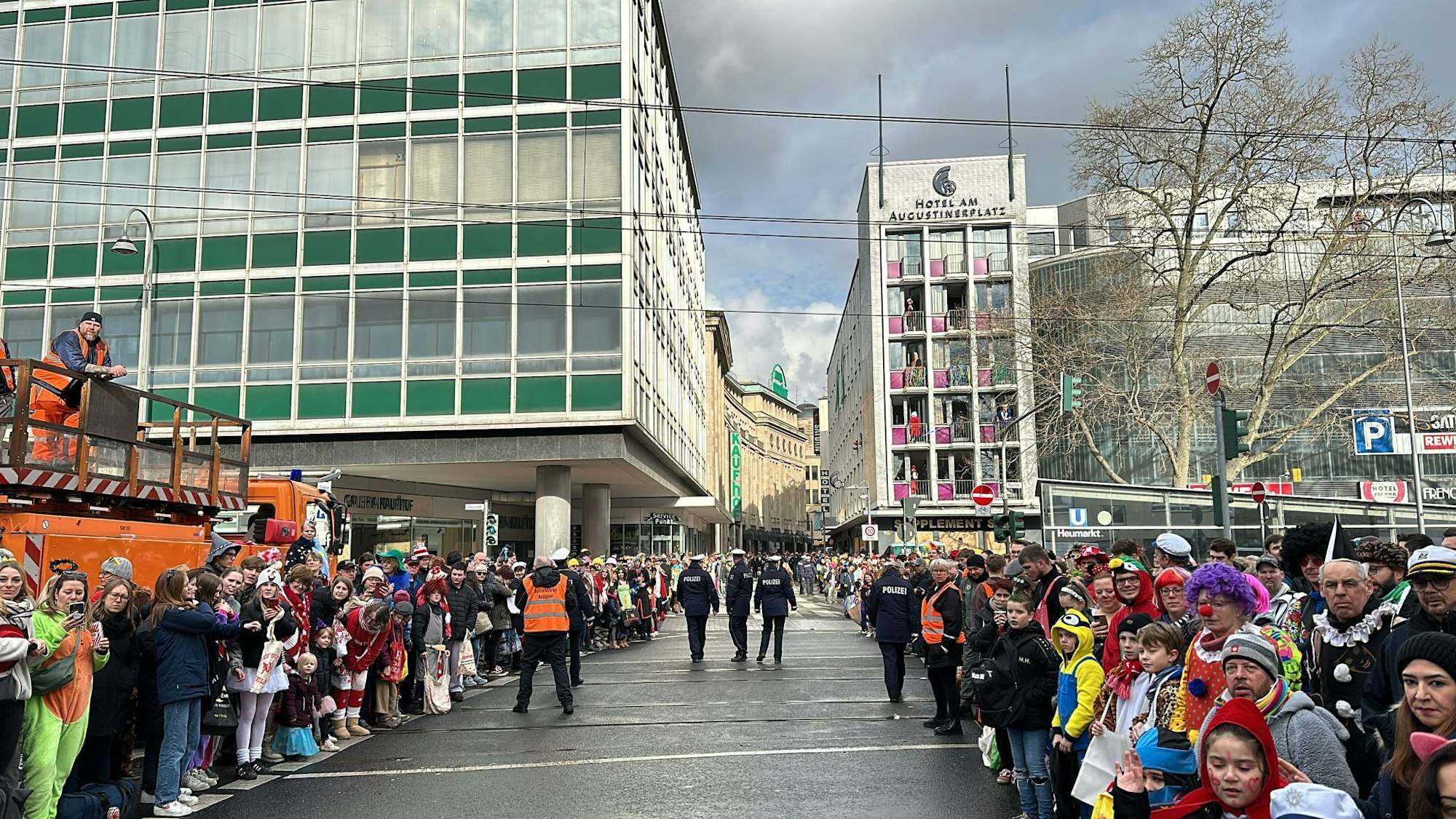 Zahlreiche Jecke stehen am Rande des Rosenmontagszugs in Köln.