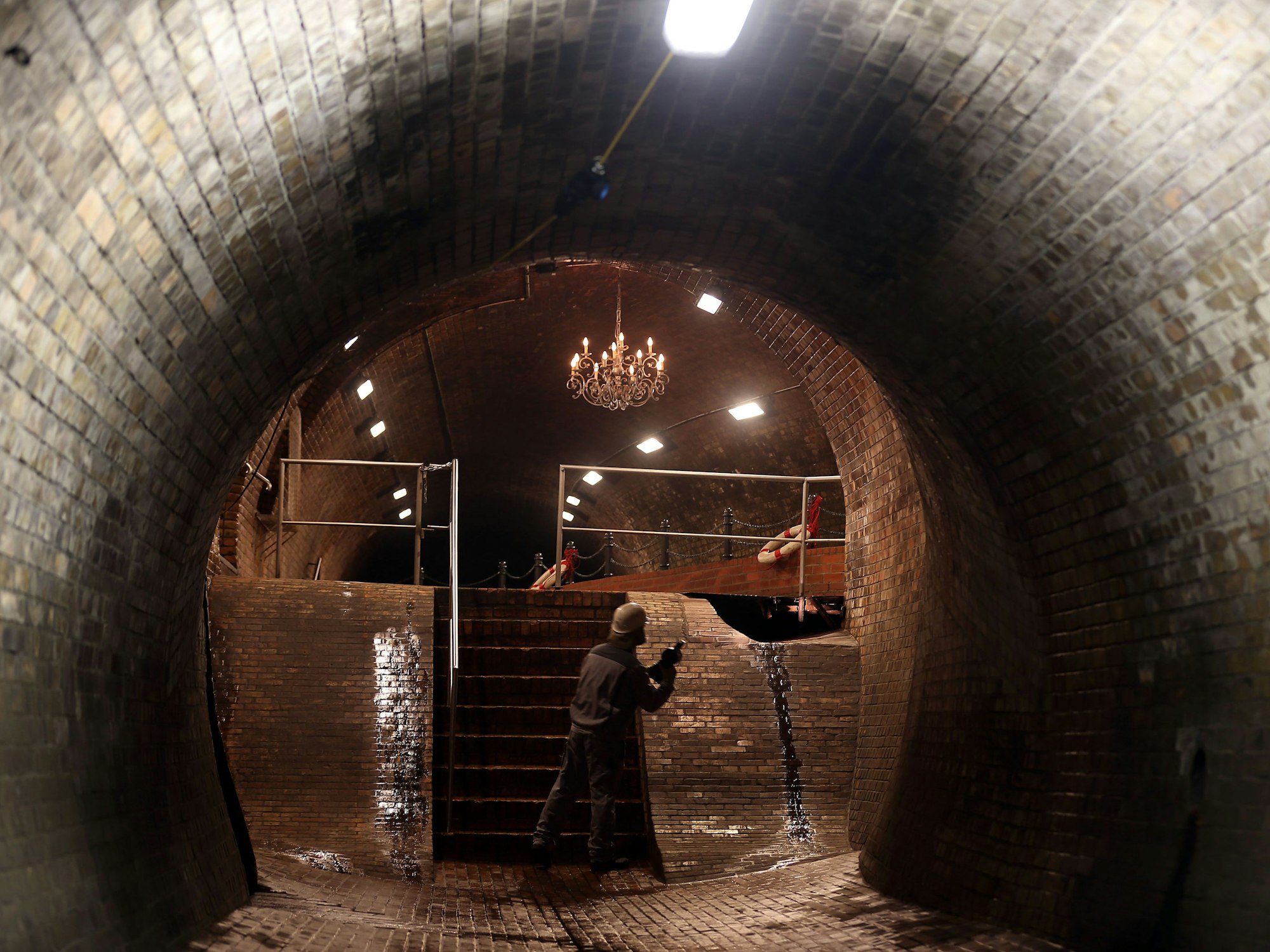Ein Mitarbeiter der Stadtentwässerungbetriebe geht durch den „Kronleuchtersaal“ in der Kölner Kanalisation.