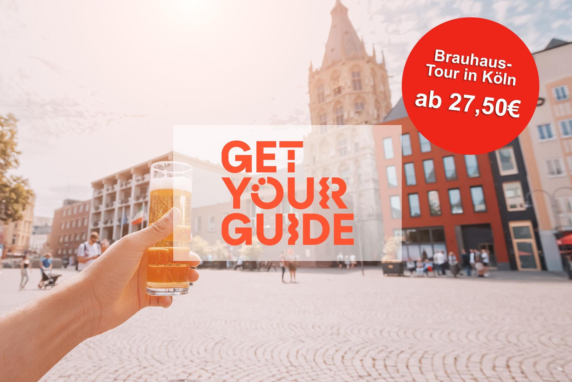 Hand with traditional Cologne koelsch beer in outdoor pub with old town square in background