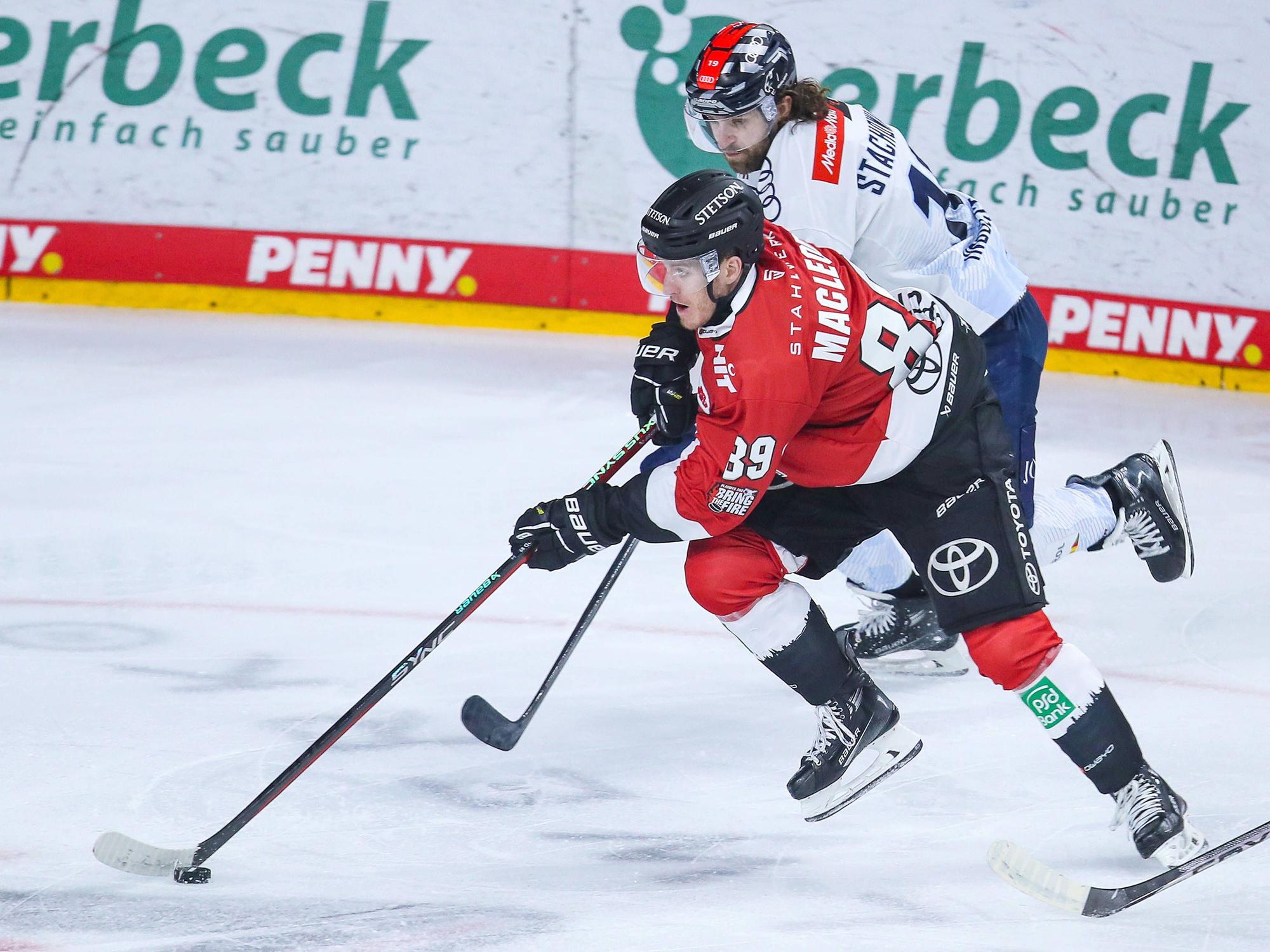 Gregor MacLeod Kölner Haie mit Puck in Aktion.
