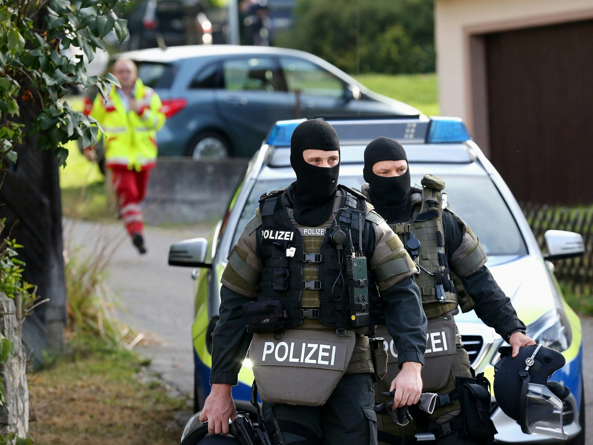 Zwei Beamte eines Spezialeinsatzkommandos (SEK) verlassen einen Tatort.