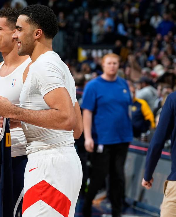 Brothers Toronto Raptors center Jontay Porter, front, and Denver Nuggets forward Michael Porter Jr. trade jerseys after an NBA basketball game, Monday, March 11, 2024, in Denver. (AP Photo/David Zalubowski)