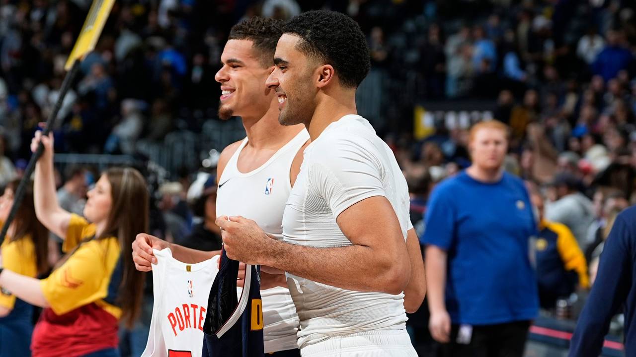 Brothers Toronto Raptors center Jontay Porter, front, and Denver Nuggets forward Michael Porter Jr. trade jerseys after an NBA basketball game, Monday, March 11, 2024, in Denver. (AP Photo/David Zalubowski)