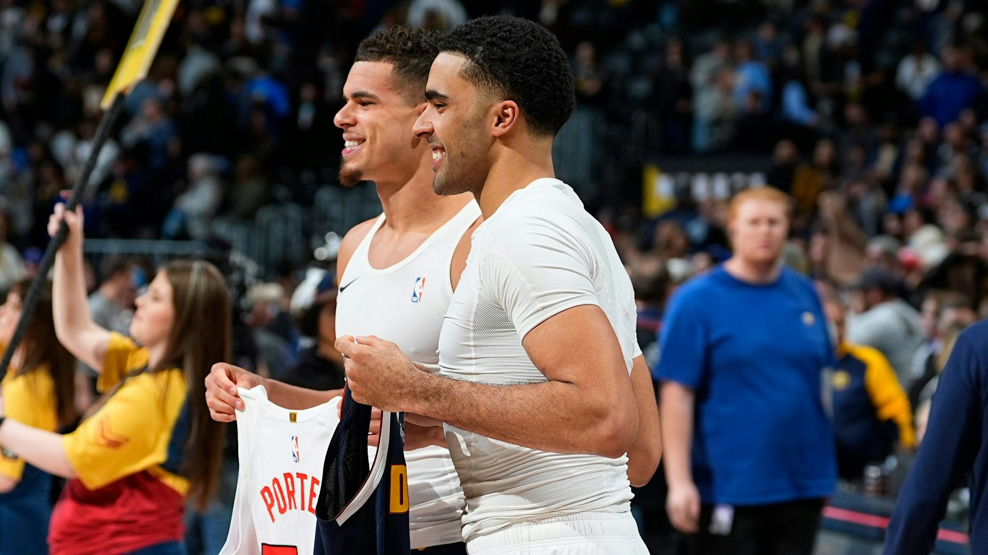 Brothers Toronto Raptors center Jontay Porter, front, and Denver Nuggets forward Michael Porter Jr. trade jerseys after an NBA basketball game, Monday, March 11, 2024, in Denver. (AP Photo/David Zalubowski)