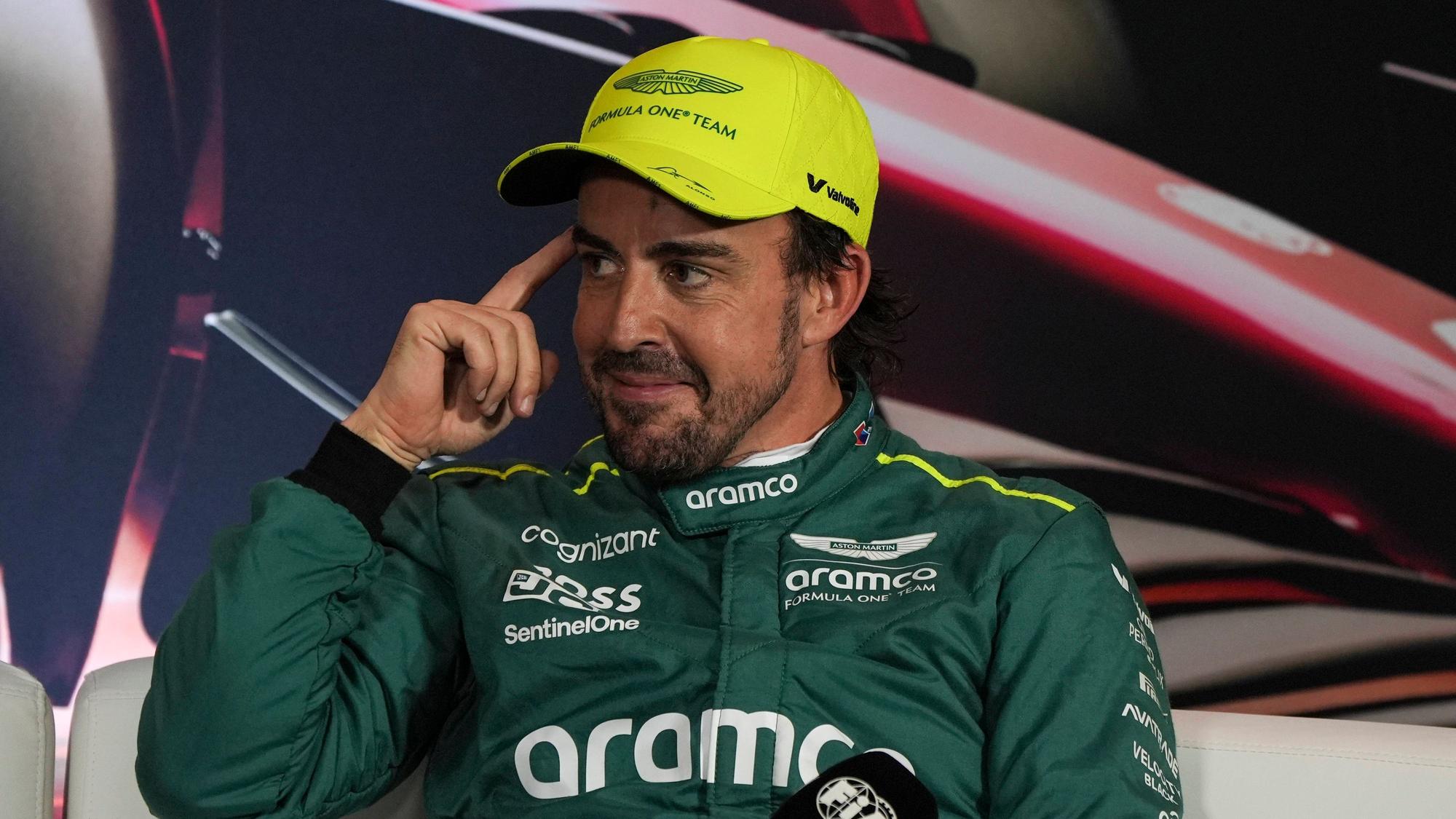 Fernando Alonso lächelt schelmisch bei einer Pressekonferenz der Formel 1.