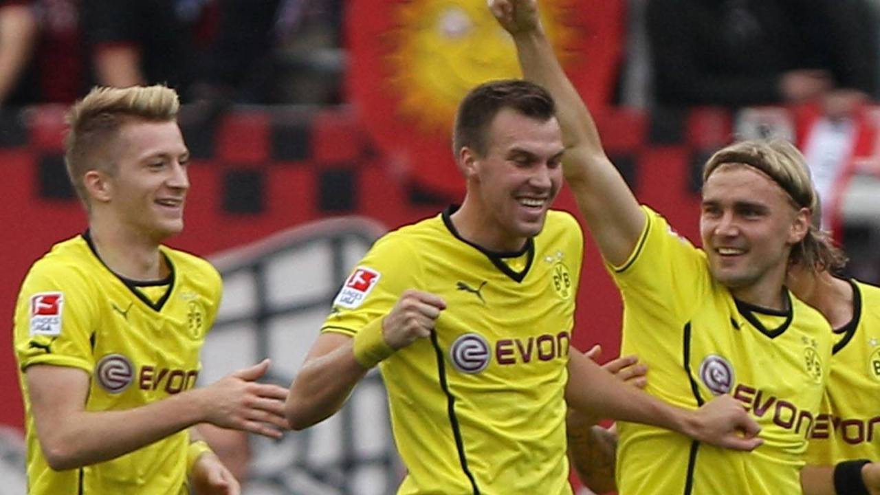 Marco Reus, Kevin Großkreutz und Marcel Schmelzer jubeln gemeinsam.