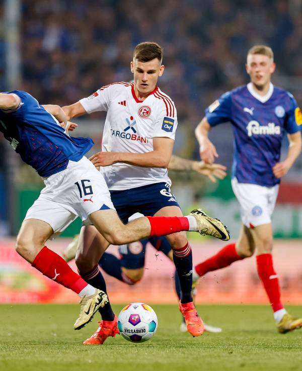 Holstein Kiels Philipp Sander im Zweikampf mit Fortuna Düsseldorfs Yannik Engelhardt.