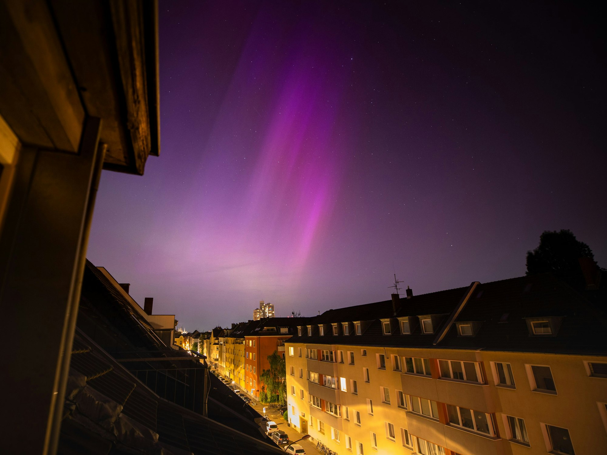 Polarlichter (Aurora Borealis) sind in der Nacht von Freitag auf Samstag (11. Mai 2024) am Nachthimmel über dem Kölner Ortsteil Sülz zu sehen. Nach einem außergewöhnlich starkem Sonnensturm, der das Magnetfeld der Erde stört, ist das Naturphänomen in ganz Europa bis weit in den Süden sichtbar. Selbst in der hellen Großstadt waren das Polarlicht mit bloßem Auge zu erkennen.