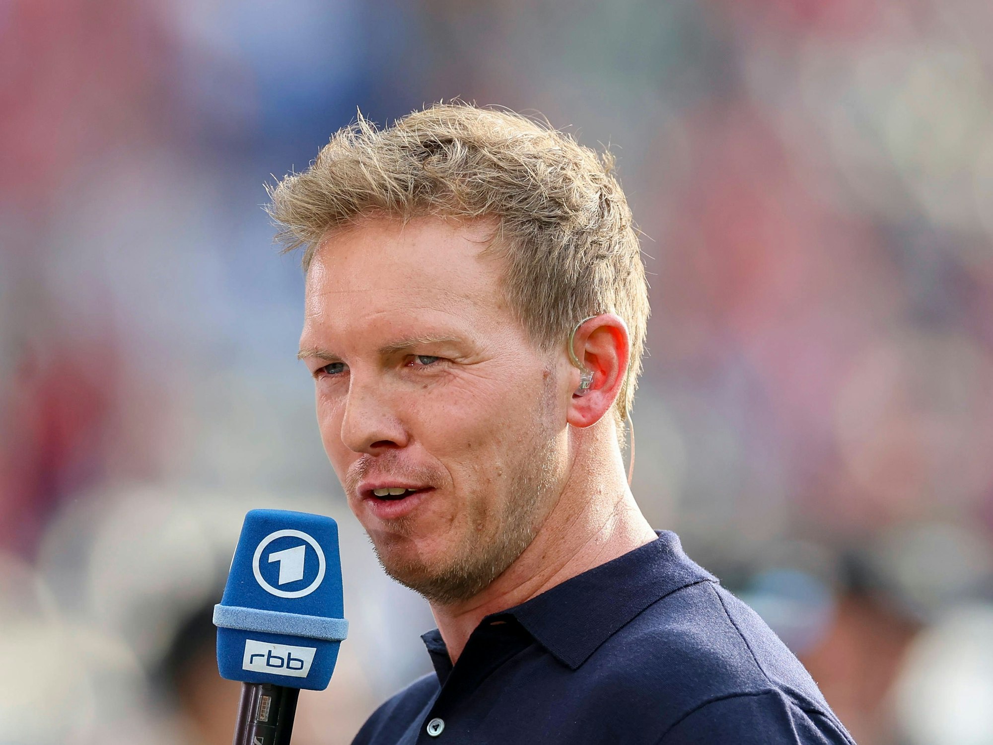 Julian Nagelsmann mit einem ARD-Mikrofon am Rande des DFB-Pokalfinales in Berlin.