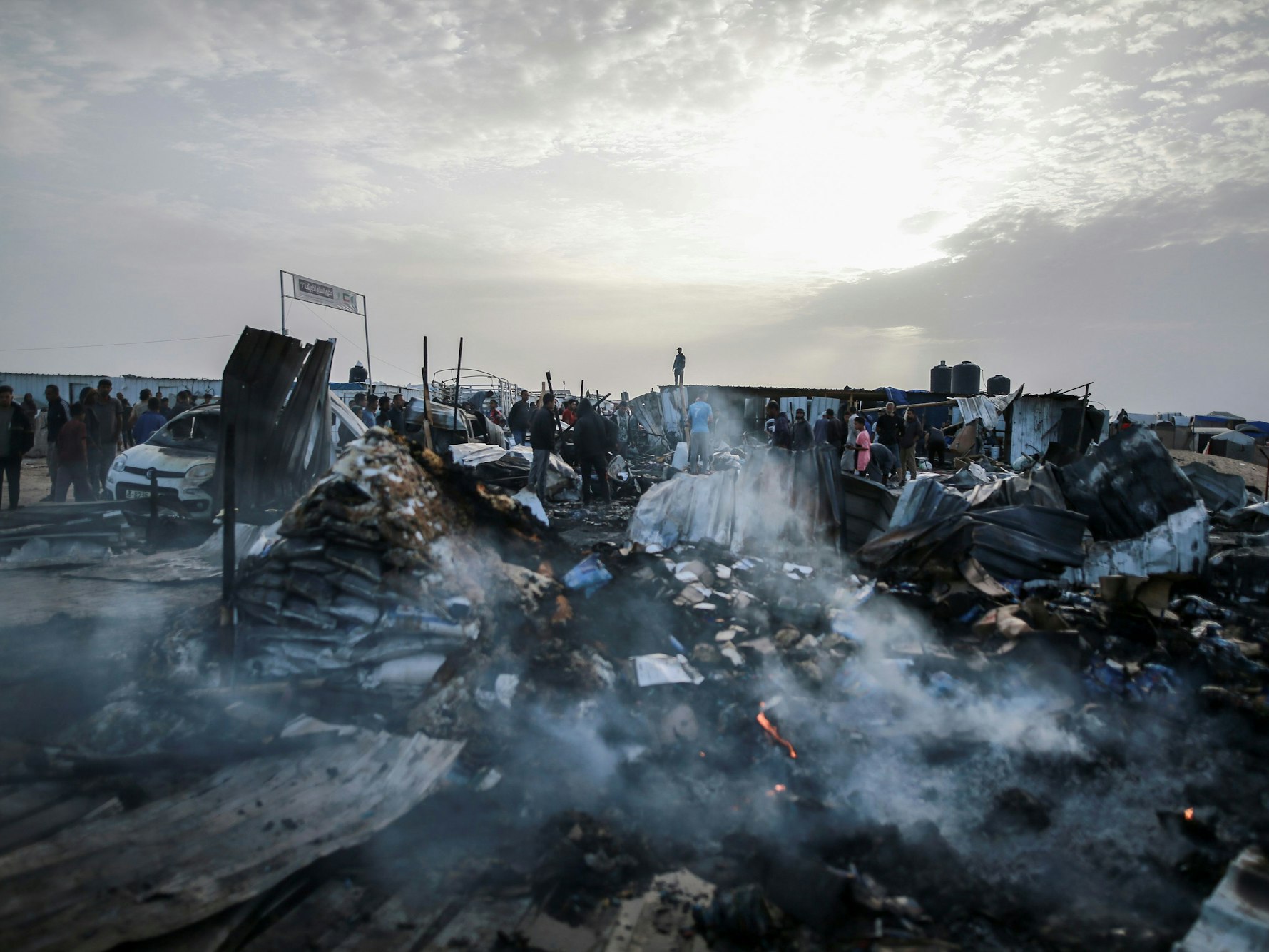Palästinenserinnen und Palästinenserinnen betrachten die Zerstörung nach einem israelischen Luftangriff auf ein Flüchtlingslager. Es gab Tote und Verletzte.