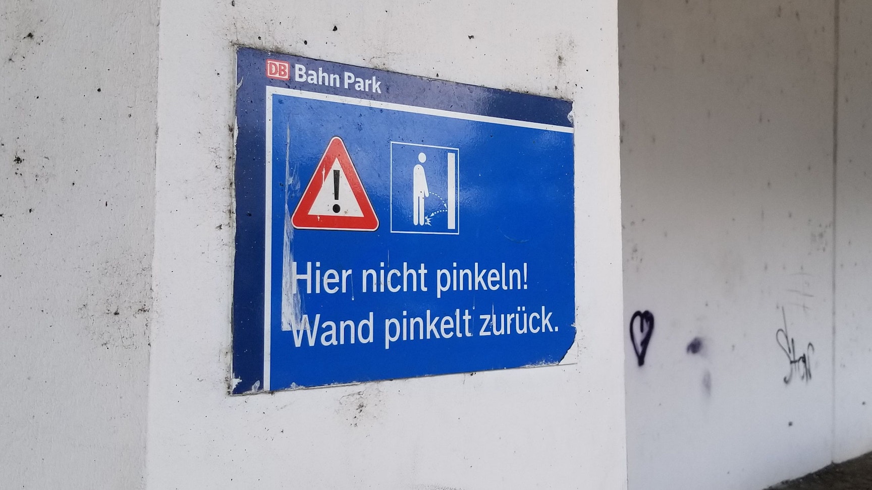 Ein Schild am Kölner Hauptbahnhof soll Wildpinkler warnen.